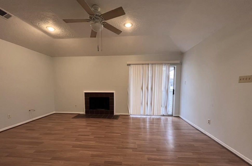 11500 Meadow Lane, Unit 4 Houston, TX 77477 - Photo 18 of 32 an empty room with wooden floor and windows