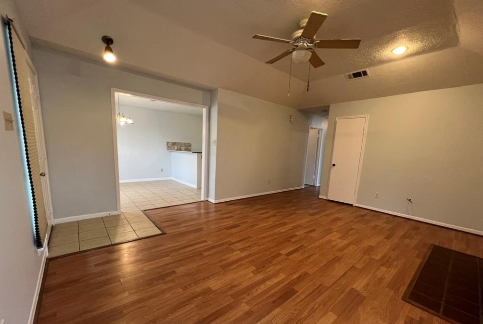 11500 Meadow Lane, Unit 4 Houston, TX 77477 - Photo 19 of 32 an empty room with wooden floor and a ceiling fan