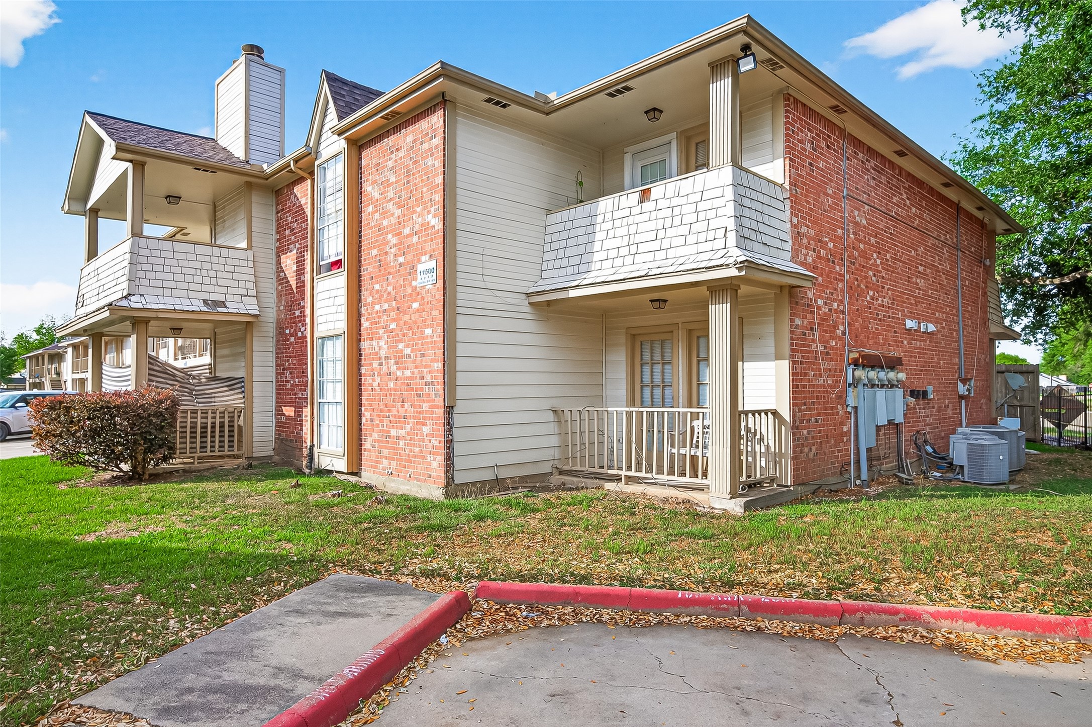 11500 Meadow Lane, Unit 4 Houston, TX 77477 - Photo 2 of 32 a view of a house with brick walls plants and large tree