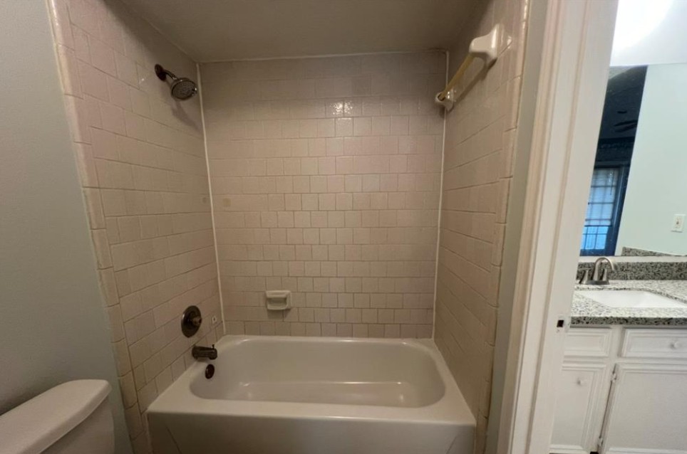 11500 Meadow Lane, Unit 4 Houston, TX 77477 - Photo 22 of 32 a bathroom with a tub and a sink