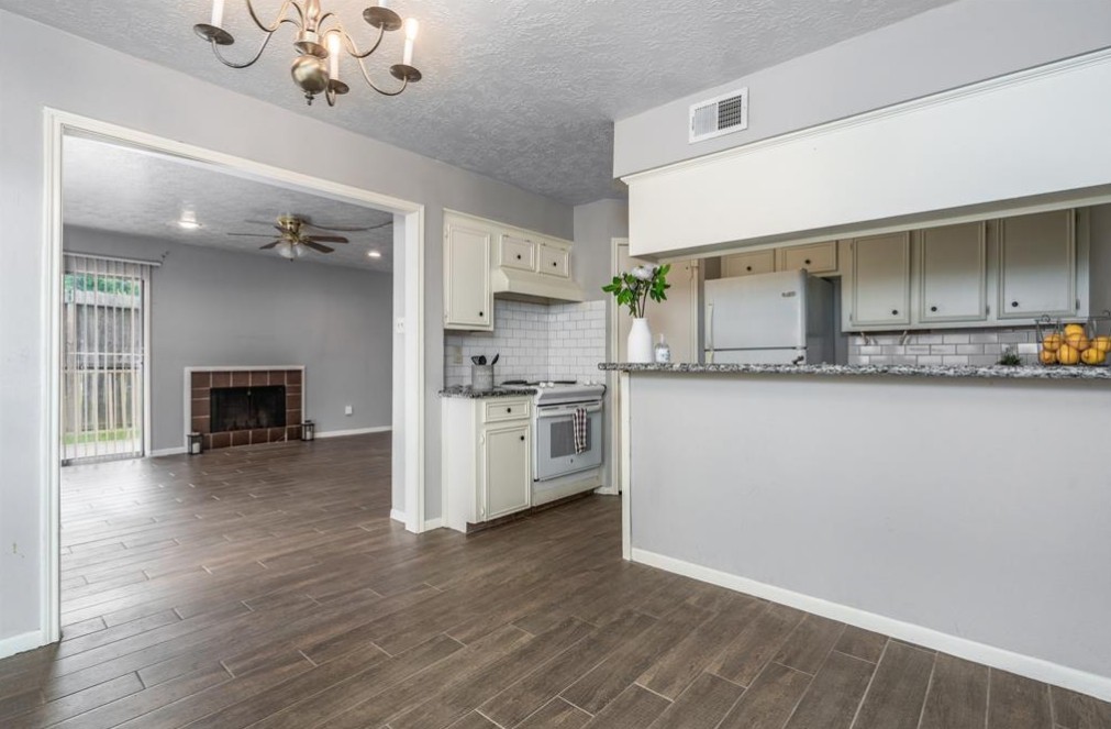 11500 Meadow Lane, Unit 4 Houston, TX 77477 - Photo 8 of 32 a kitchen with a refrigerator and a stove top oven