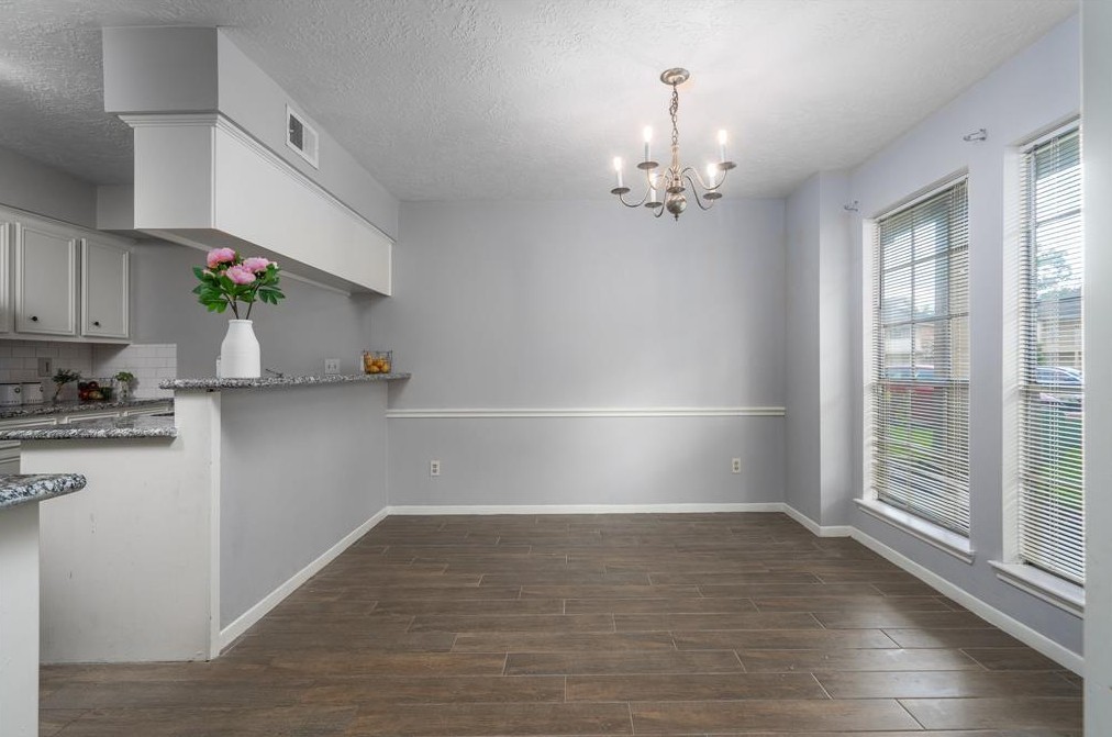 11500 Meadow Lane, Unit 4 Houston, TX 77477 - Photo 9 of 32 an empty room with wooden floor and windows
