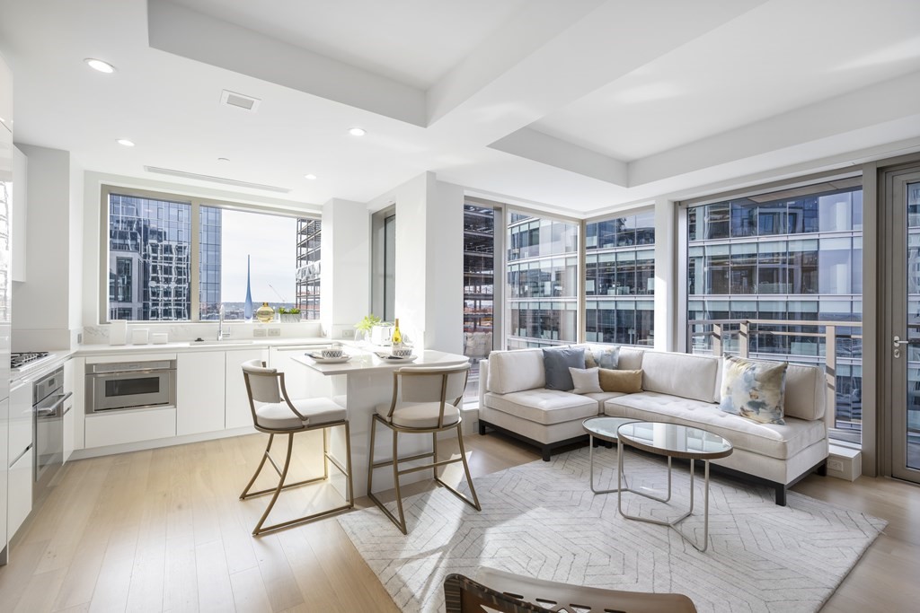 133 Seaport Boulevard, Unit 1603 Boston, MA 02210 - Photo 2 of 21 a living room with furniture and a fireplace