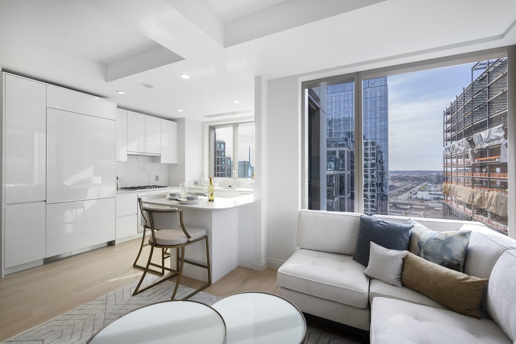 133 Seaport Boulevard, Unit 1603 Boston, MA 02210 - Photo 3 of 21 a living room with furniture and a large window