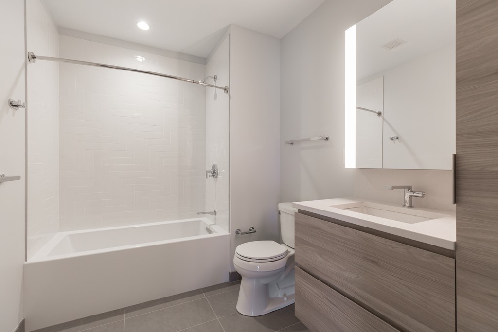 133 Seaport Boulevard, Unit 1603 Boston, MA 02210 - Photo 5 of 21 a bathroom with a toilet sink and a bathtub