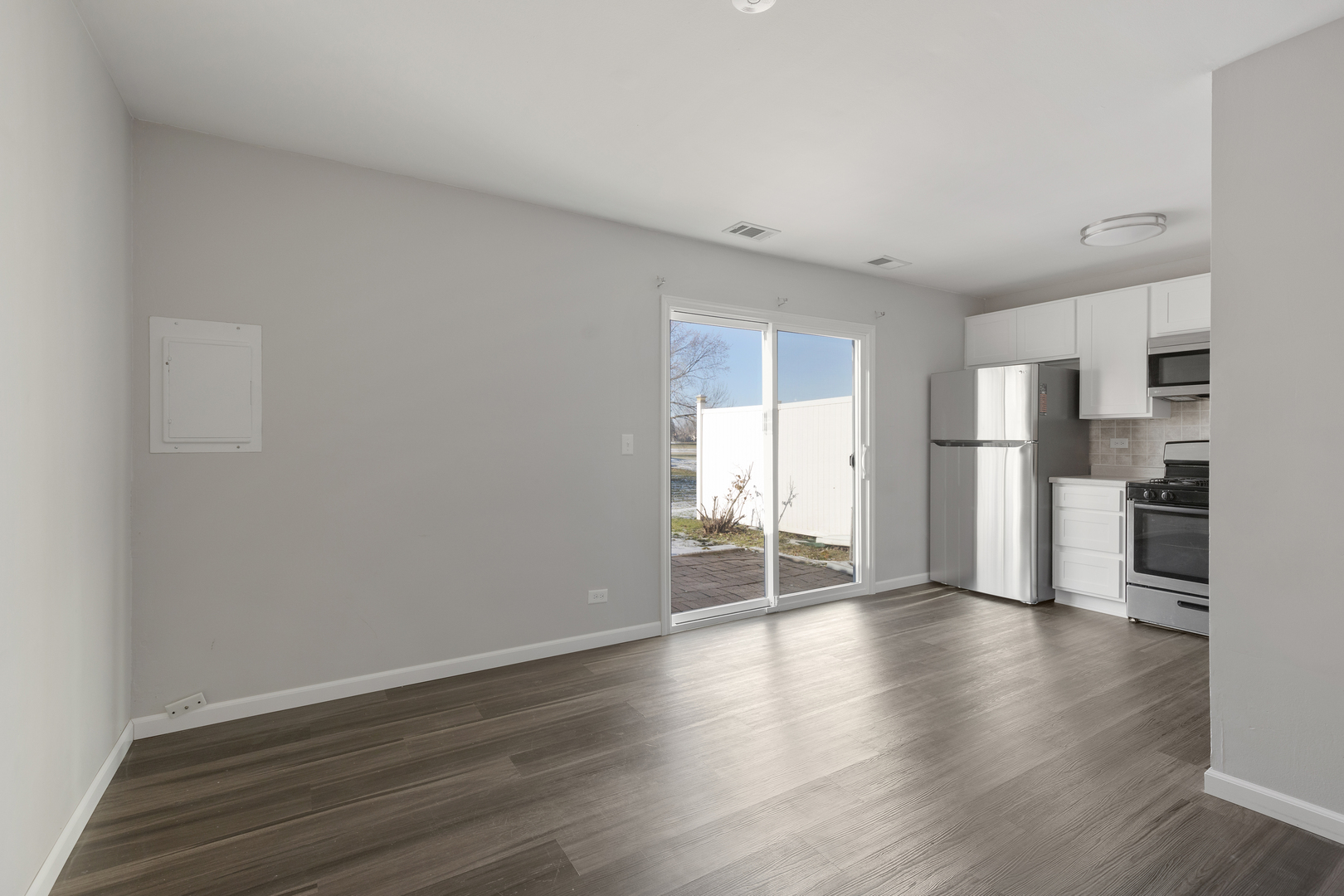318 Rodenburg Road Roselle, IL 60172 - Photo 4 of 14 a view of empty room with wooden floor and kitchen