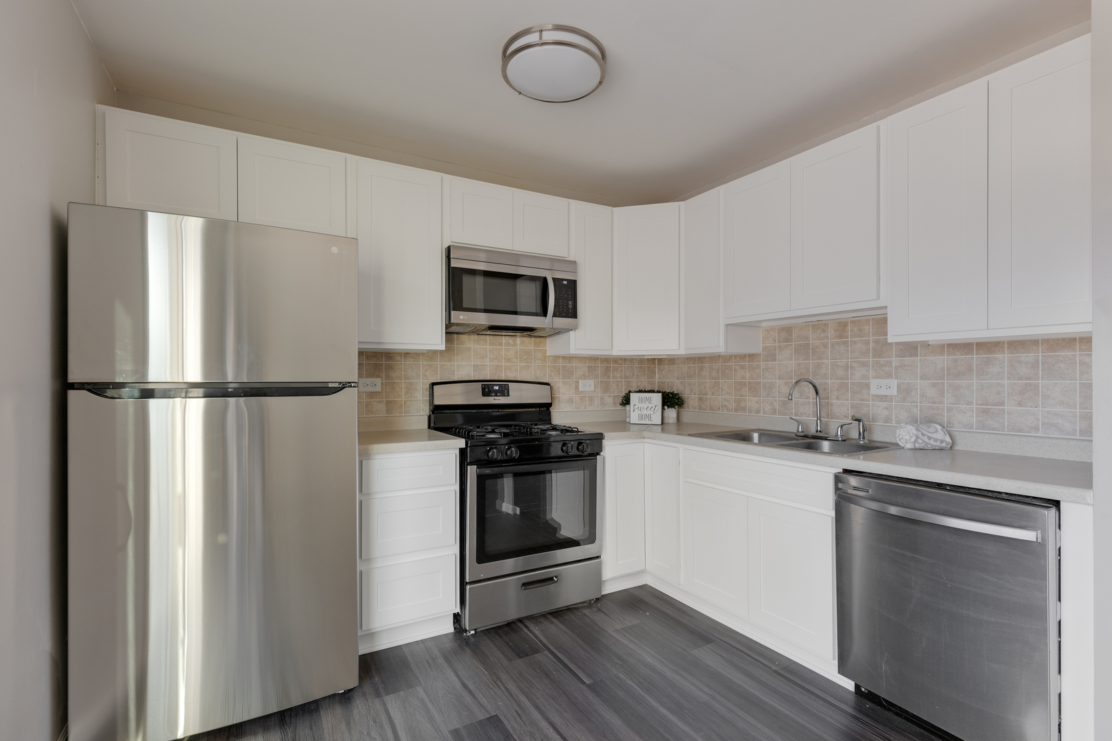 318 Rodenburg Road Roselle, IL 60172 - Photo 5 of 14 a kitchen with stainless steel appliances granite countertop a refrigerator a stove a sink and a microwave
