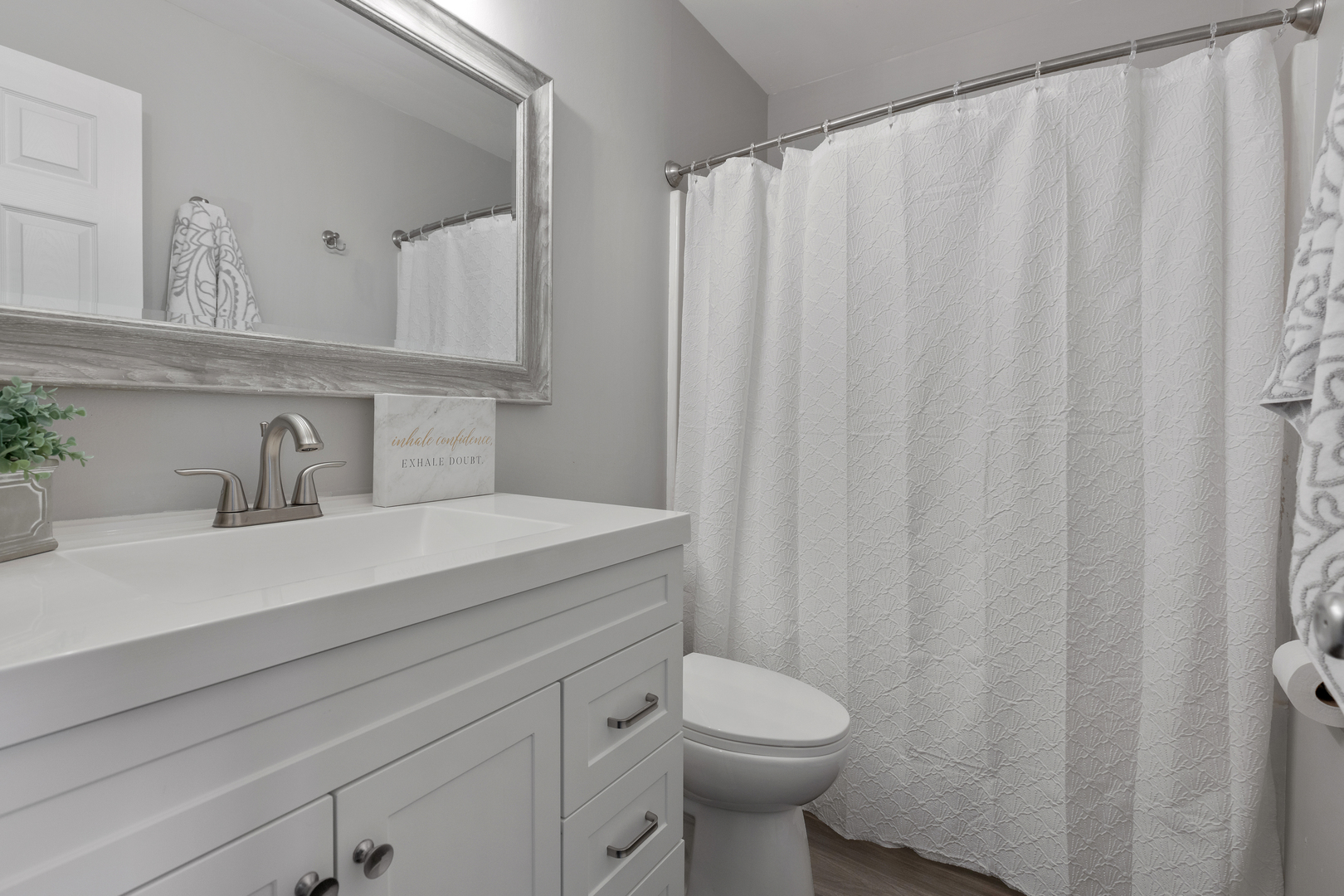318 Rodenburg Road Roselle, IL 60172 - Photo 9 of 14 a bathroom with a sink a toilet and a mirror