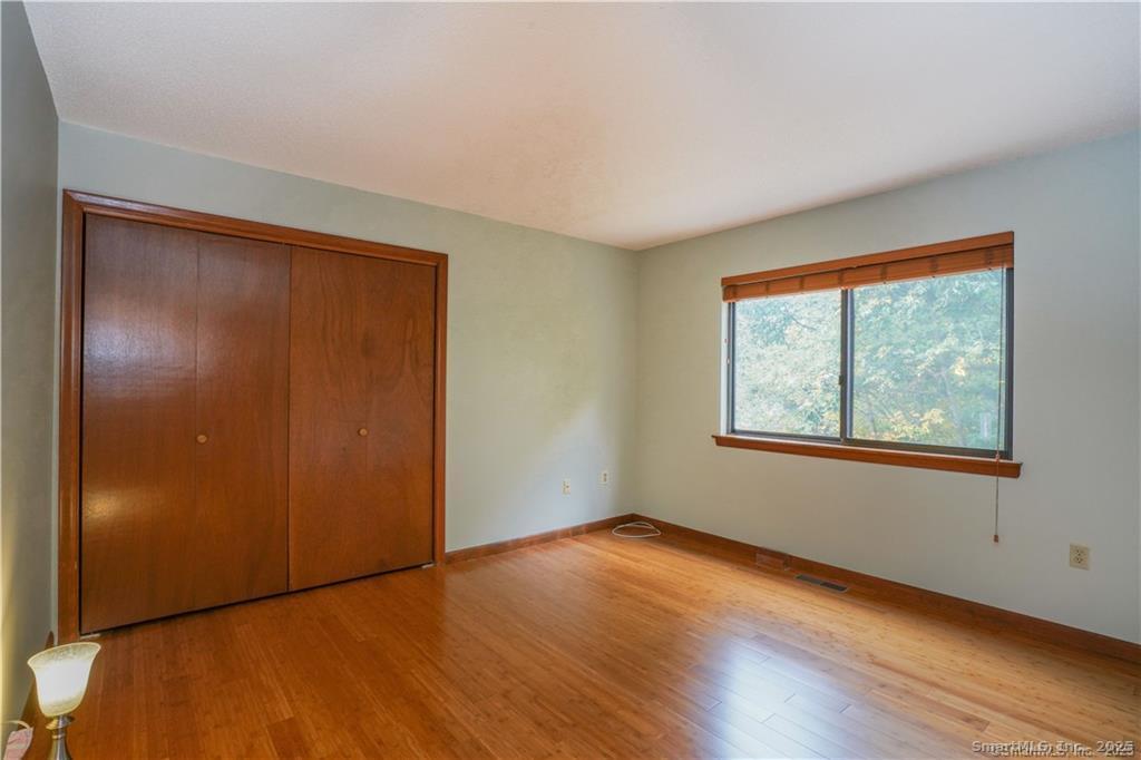 9 Red Stone Way, Unit 9 Farmington, CT 06032 - Photo 12 of 17 an empty room with wooden floor and windows