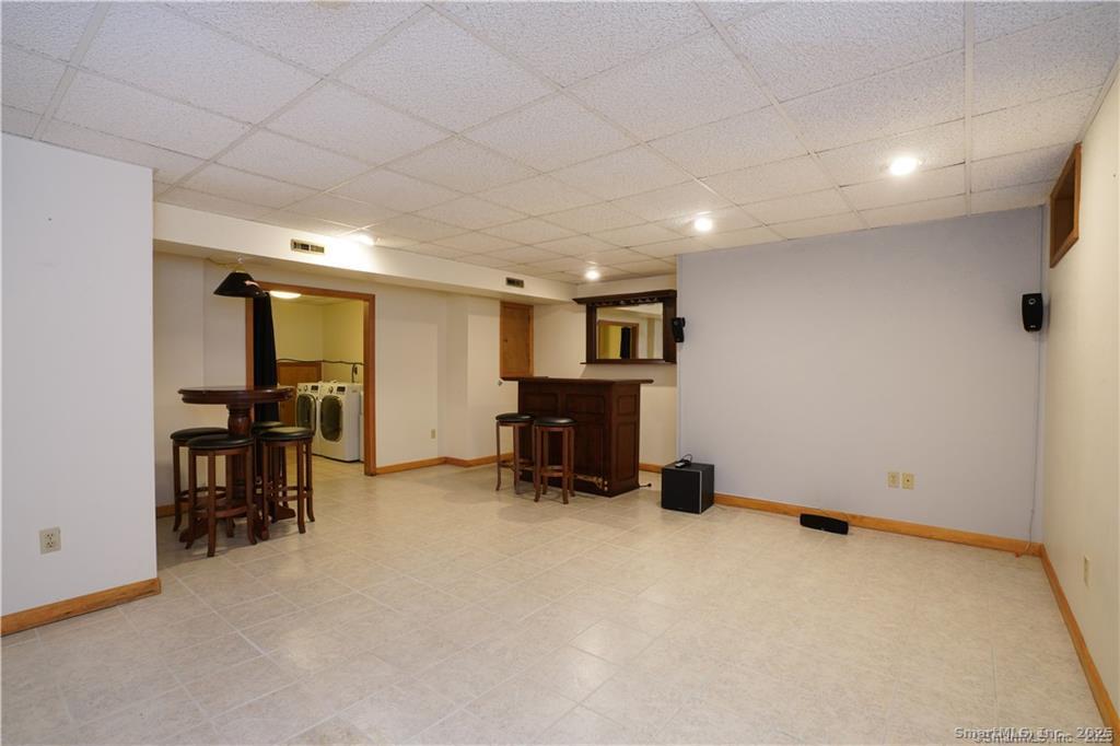 9 Red Stone Way, Unit 9 Farmington, CT 06032 - Photo 15 of 17 an empty room with furniture and a chair