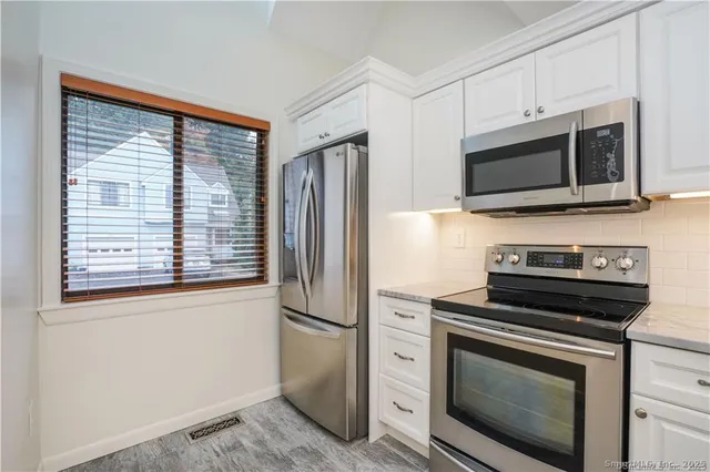 a kitchen with a stove microwave and refrigerator