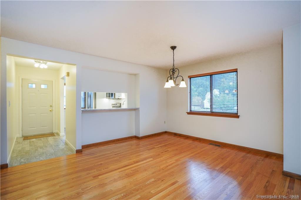 9 Red Stone Way, Unit 9 Farmington, CT 06032 - Photo 4 of 17 wooden floor in an empty room with a window