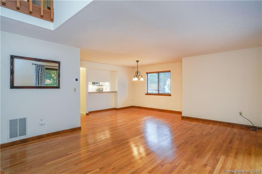 9 Red Stone Way, Unit 9 Farmington, CT 06032 - Photo 5 of 17 a view of an empty room with window and wooden floor