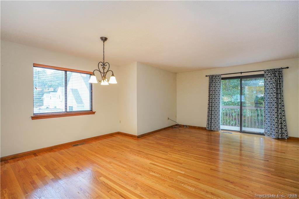9 Red Stone Way, Unit 9 Farmington, CT 06032 - Photo 6 of 17 a view of empty room with wooden floor and fan