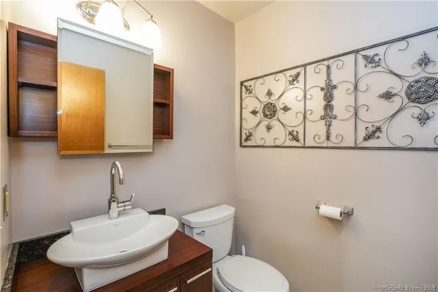 a bathroom with a toilet sink and mirror