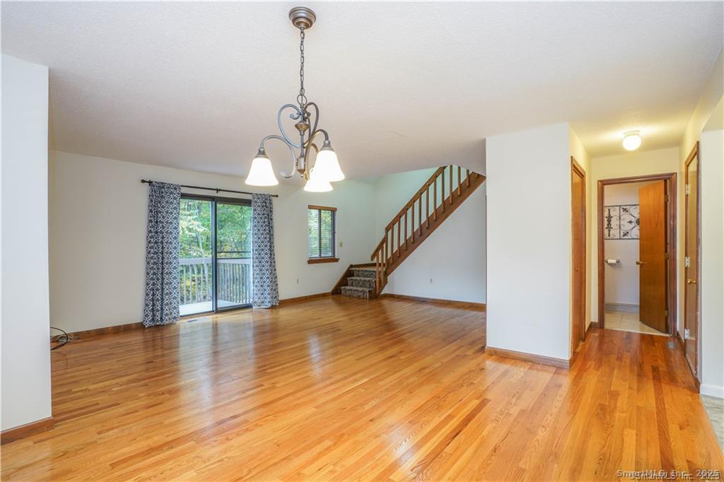 9 Red Stone Way, Unit 9 Farmington, CT 06032 - Photo 8 of 17 a view of empty room with wooden floor and fan