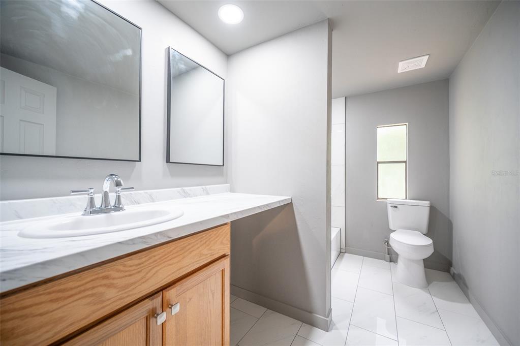 5027 Southwest 69 Street Gainesville, FL 32608 - Photo 12 of 21 a bathroom with a sink and a mirror