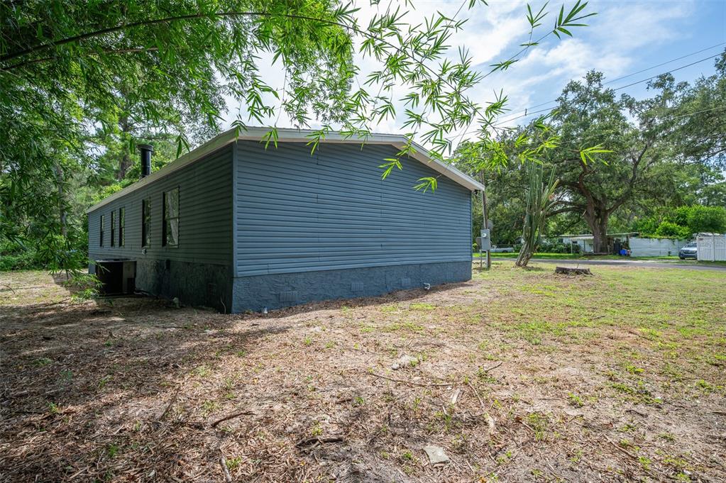 5027 Southwest 69 Street Gainesville, FL 32608 - Photo 20 of 21 a backyard of house with large trees