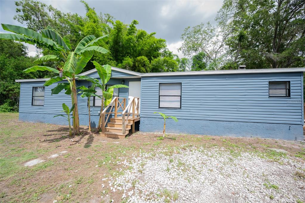 5027 Southwest 69 Street Gainesville, FL 32608 - Photo 2 of 21 a view of a house with a backyard and chairs