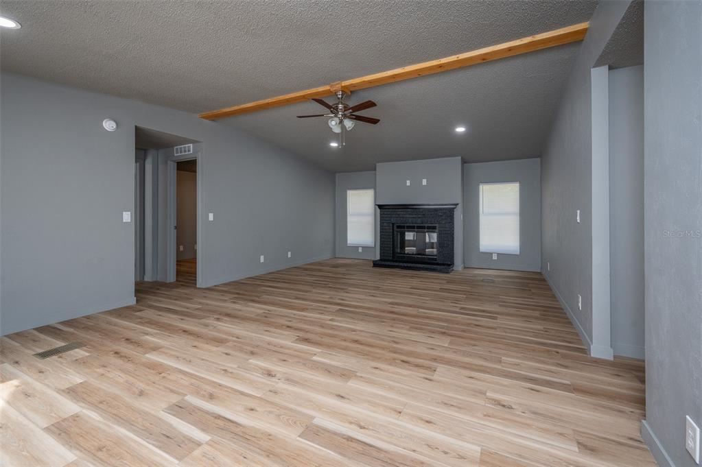 5027 Southwest 69 Street Gainesville, FL 32608 - Photo 3 of 21 a view of an empty room with a fireplace and a window