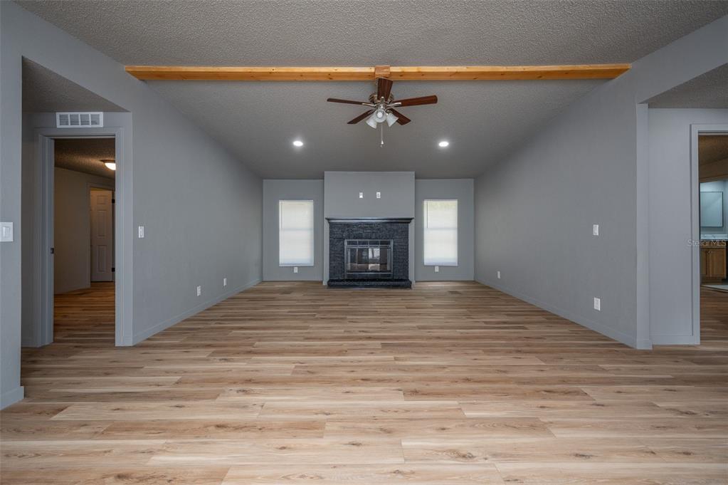 5027 Southwest 69 Street Gainesville, FL 32608 - Photo 4 of 21 a view of an empty room with a fireplace and a window