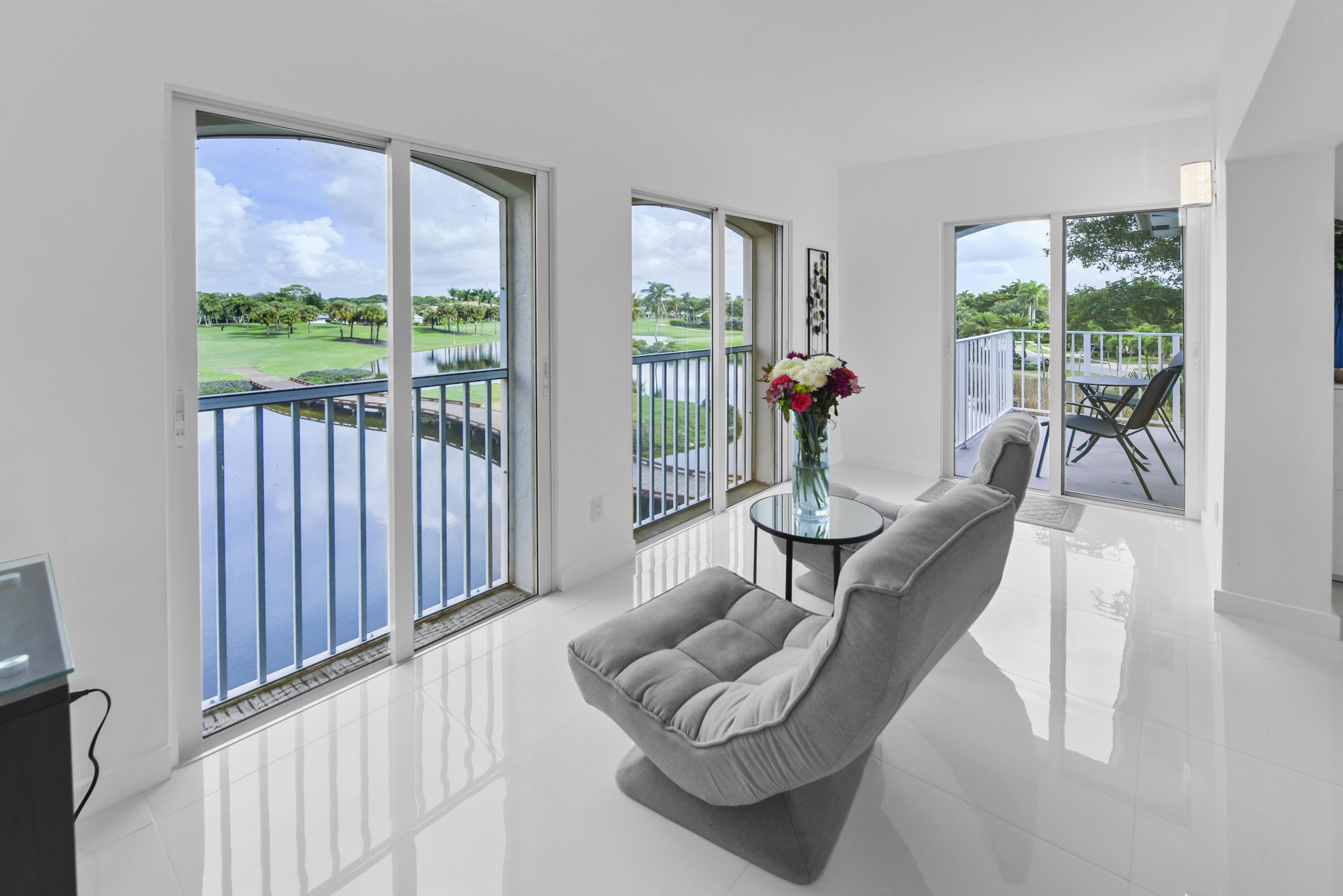 7369 Orangewood Lane, Unit 303 Boca Raton, FL 33433 - Photo 16 of 56 a living room with furniture and a large window