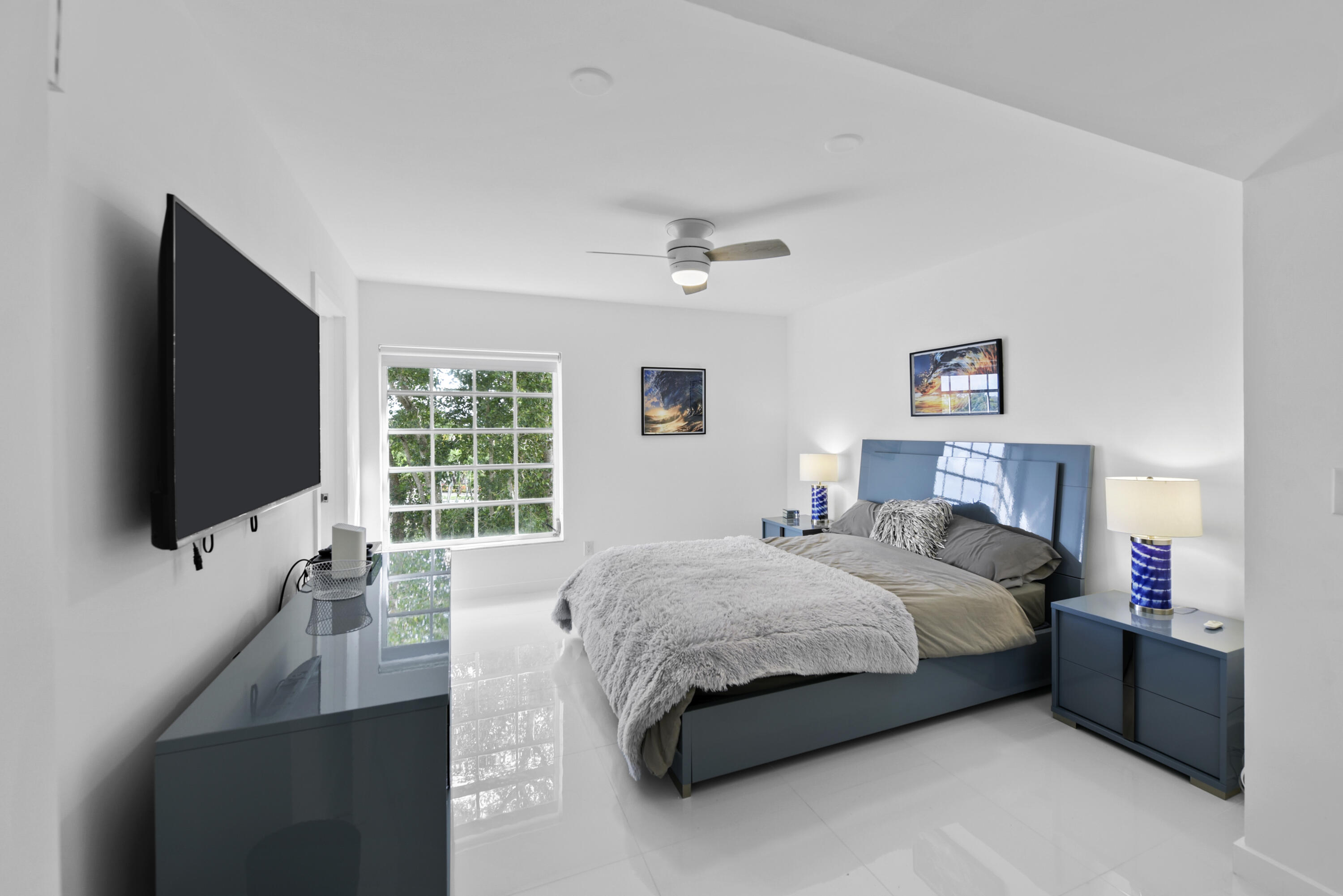 7369 Orangewood Lane, Unit 303 Boca Raton, FL 33433 - Photo 20 of 56 a bedroom with a bed and a flat screen tv