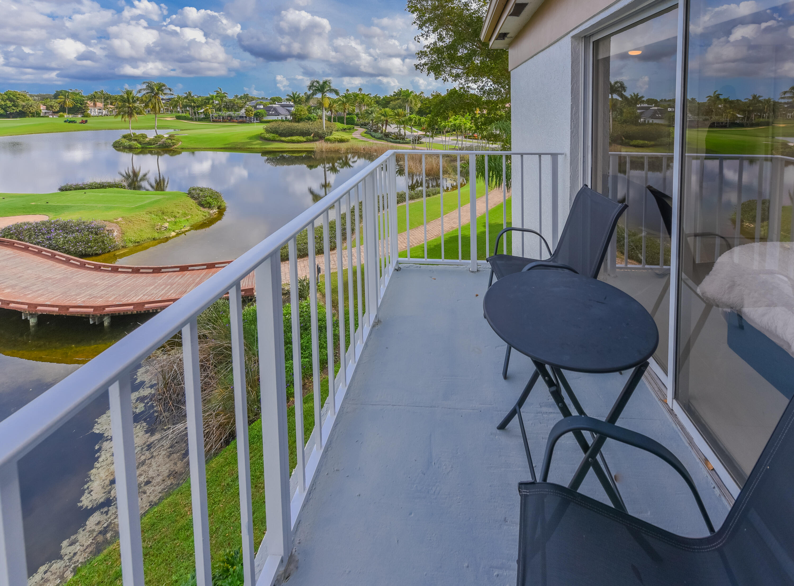 7369 Orangewood Lane, Unit 303 Boca Raton, FL 33433 - Photo 24 of 56 a view of a chairs and table in patio with a swimming pool