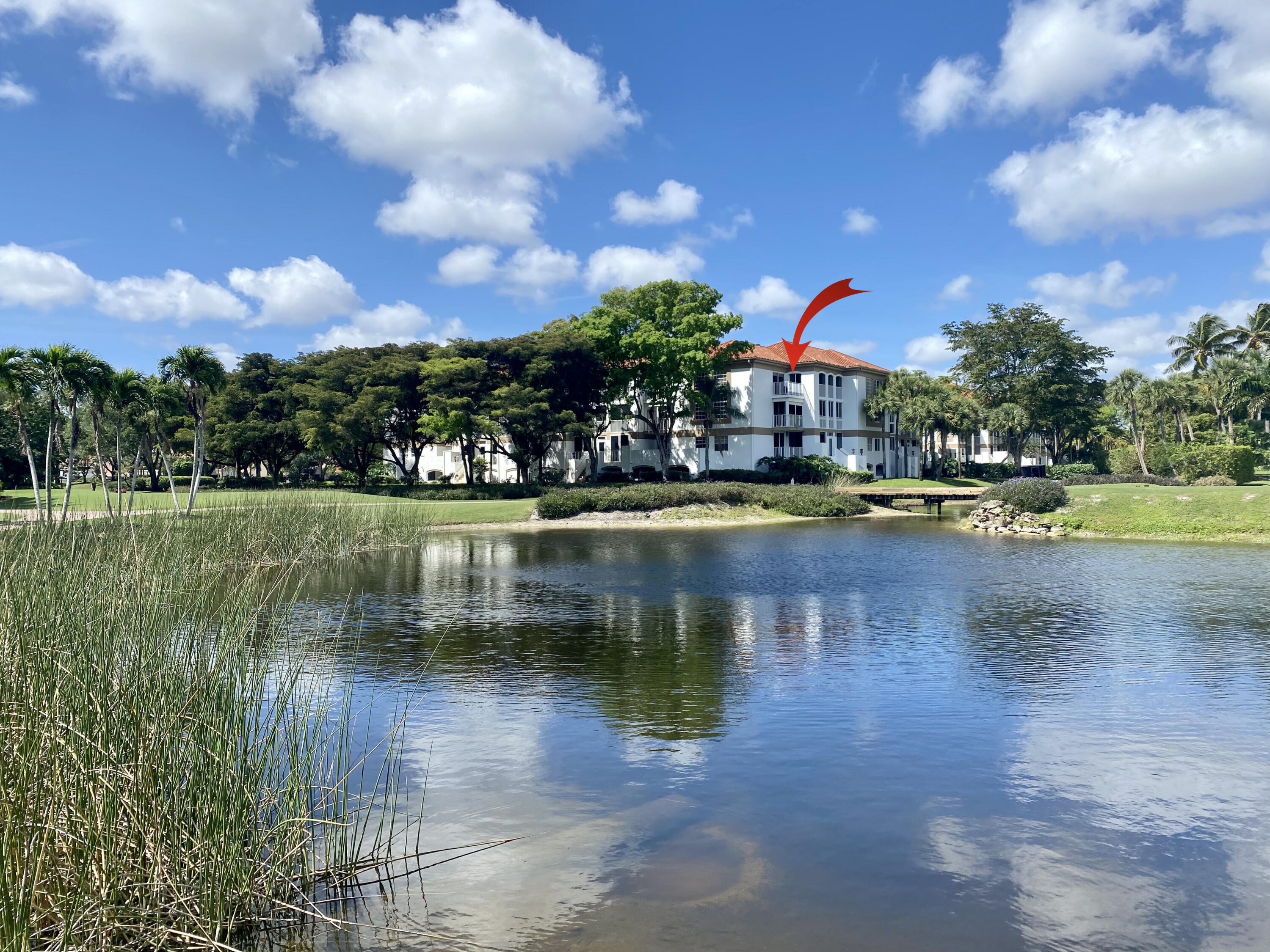 7369 Orangewood Lane, Unit 303 Boca Raton, FL 33433 - Photo 28 of 56 a view of a lake with a house in the background