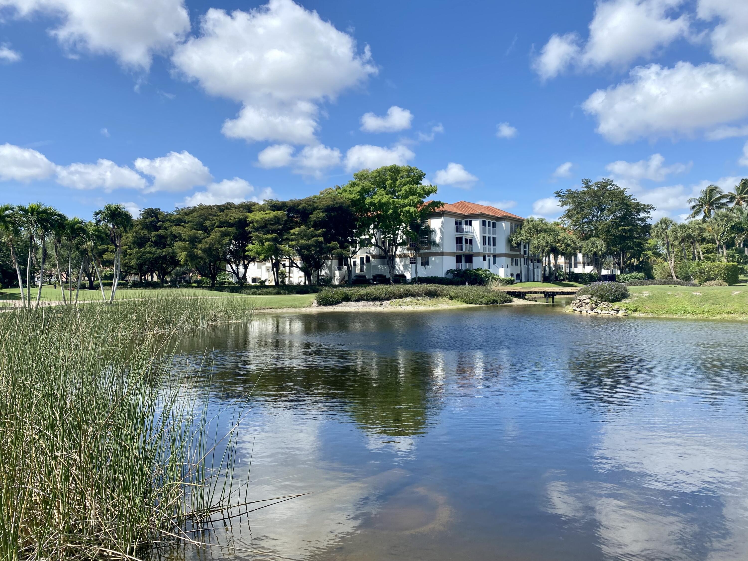 7369 Orangewood Lane, Unit 303 Boca Raton, FL 33433 - Photo 36 of 56 a view of a lake with houses in the background