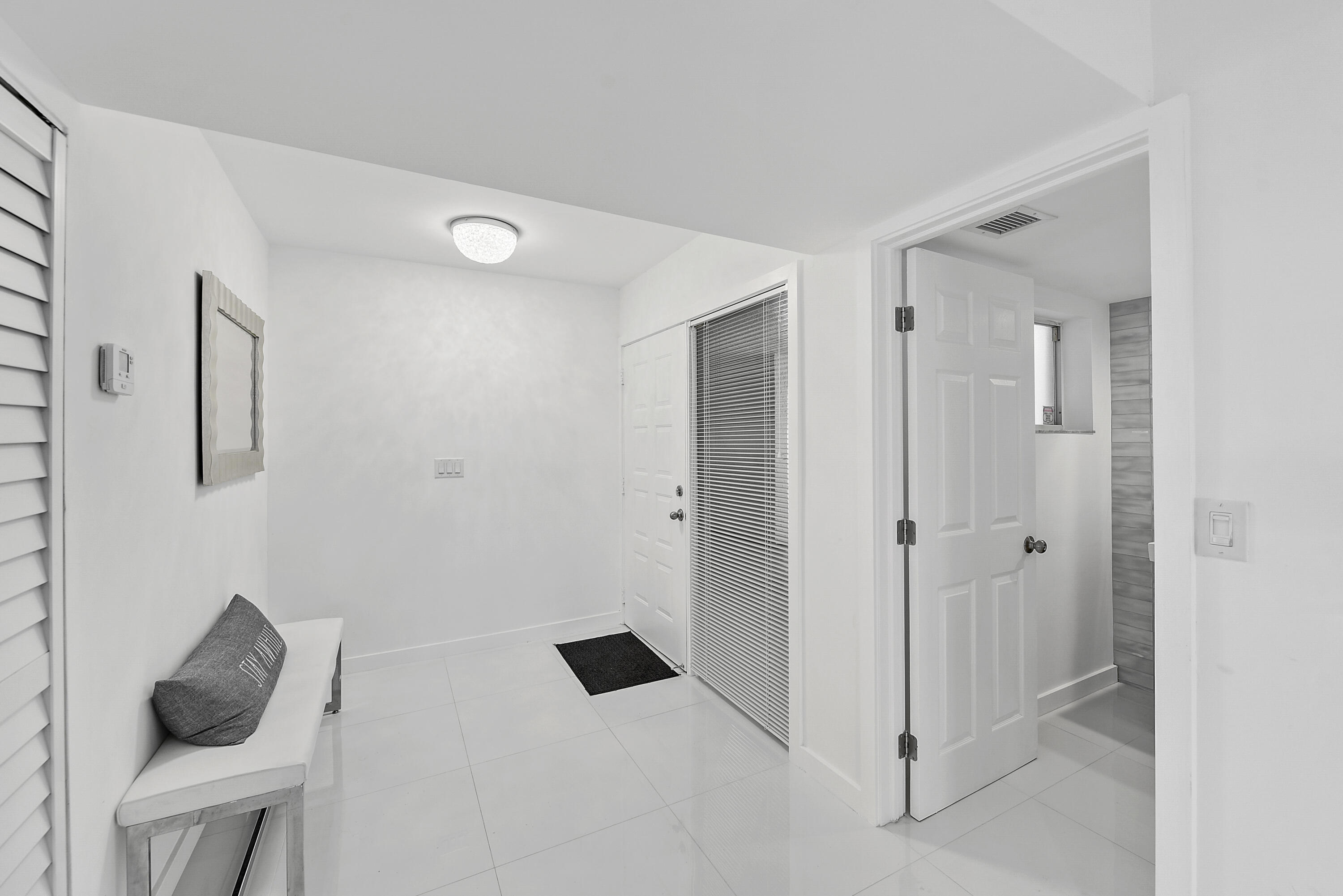 7369 Orangewood Lane, Unit 303 Boca Raton, FL 33433 - Photo 5 of 56 a view of a livingroom with wooden floor and closet