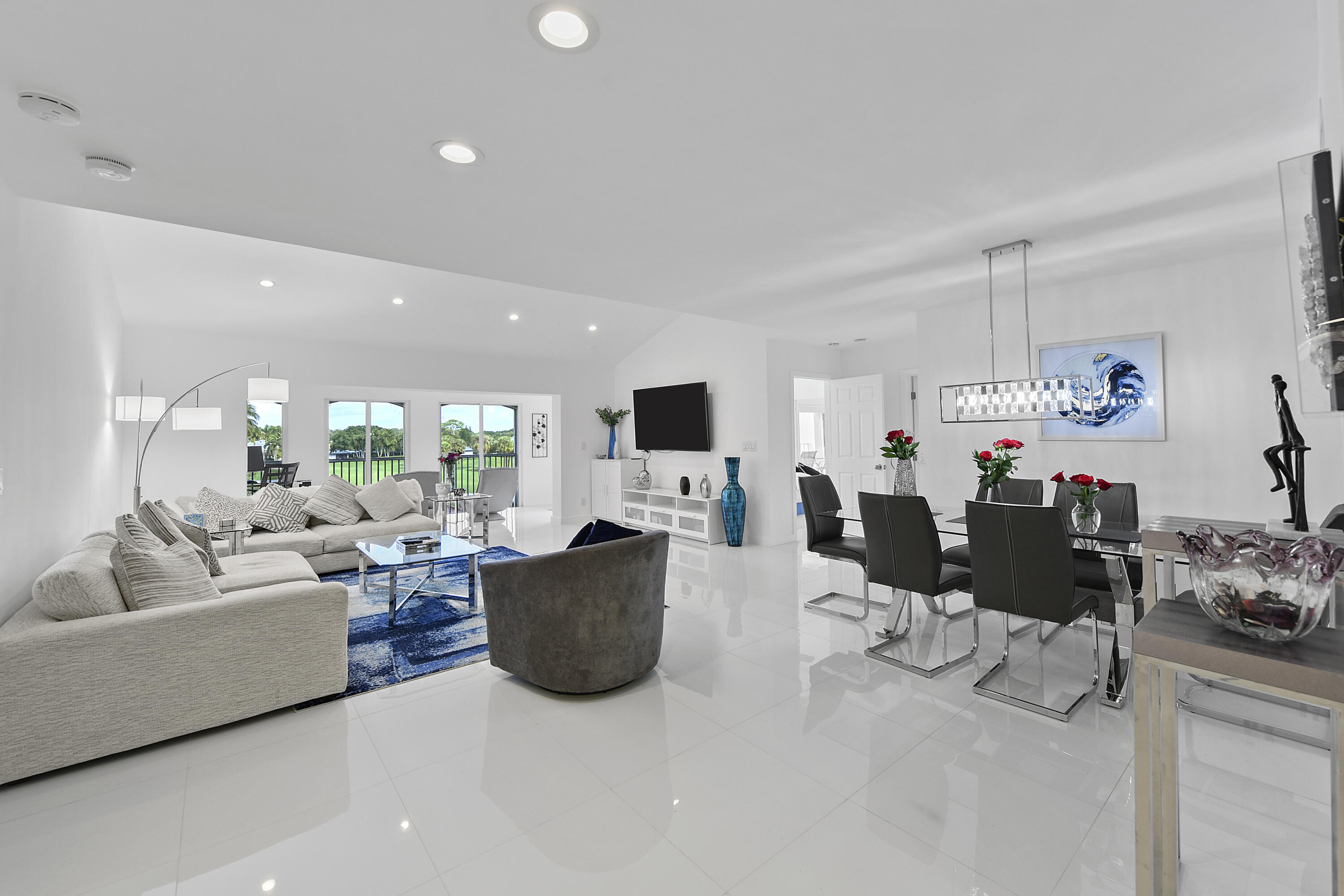 7369 Orangewood Lane, Unit 303 Boca Raton, FL 33433 - Photo 6 of 56 a living room with furniture and a flat screen tv