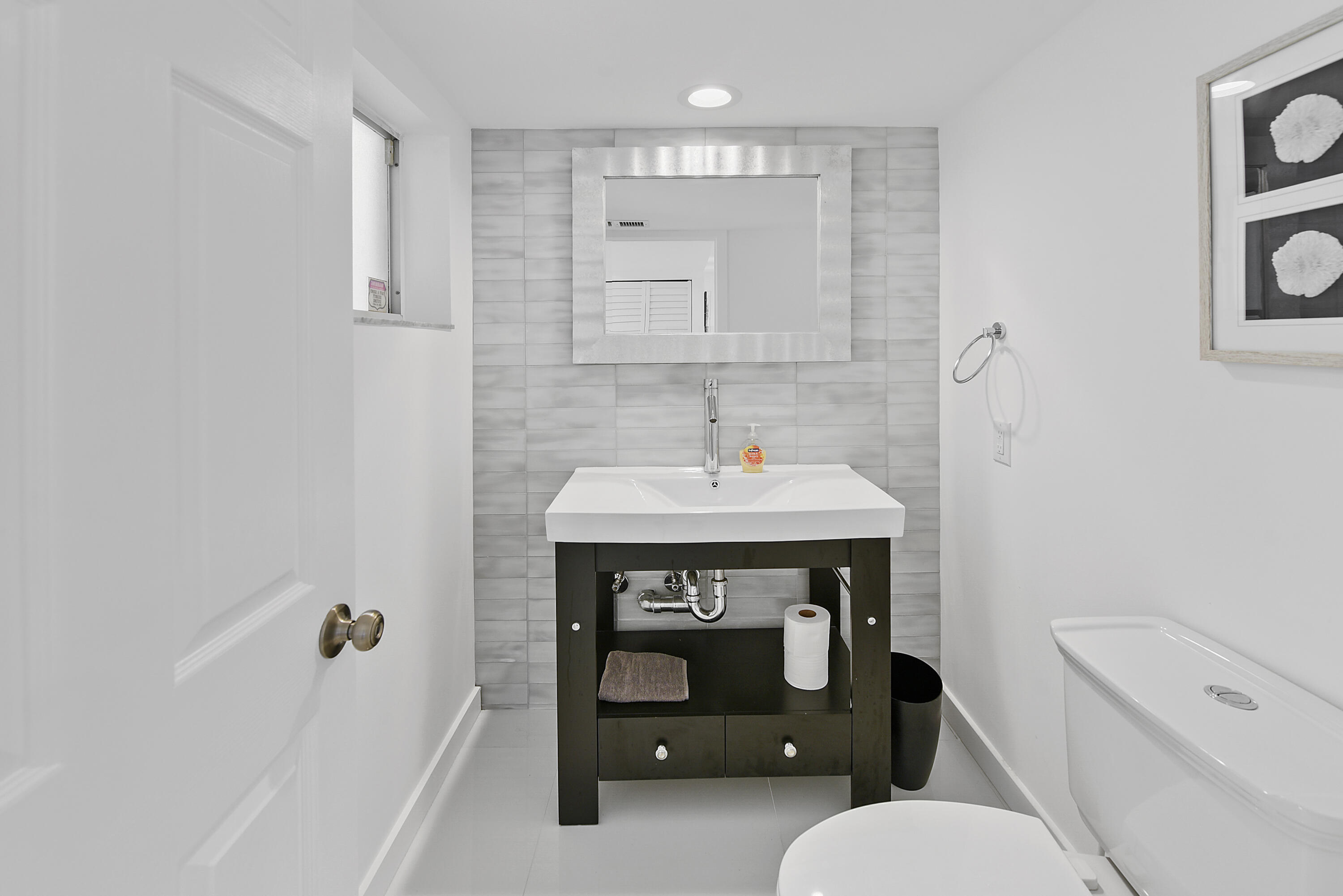 7369 Orangewood Lane, Unit 303 Boca Raton, FL 33433 - Photo 7 of 56 a bathroom with a sink a toilet and bathtub