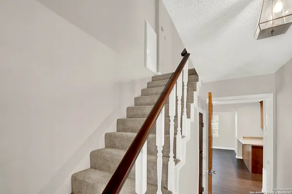 a view of entryway with wooden floor and stairs