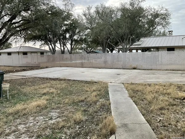 a view of a yard with trees