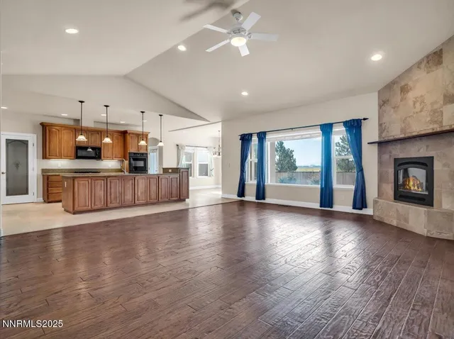 a living room with a fireplace and a floor to ceiling window