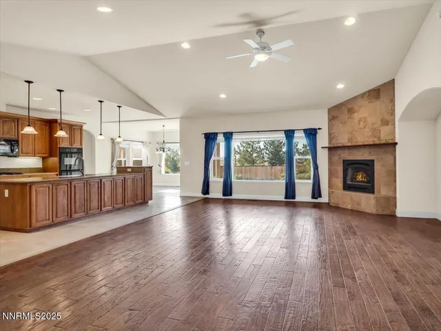 a large kitchen with kitchen island a large counter top a sink a stove and a refrigerator