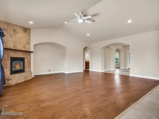 a large kitchen with stainless steel appliances kitchen island granite countertop a stove and a refrigerator