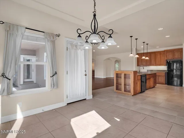 a view of an empty room with wooden floor and cabinets