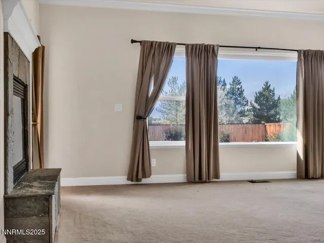 an empty room with large windows and mountain view