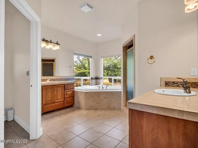 a bathroom with a sink double vanity and a bathtub