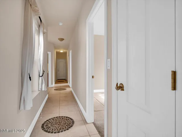 a view of a backyard with a barbeque and wooden fence