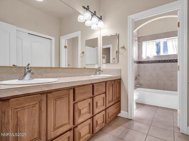 an aerial view of residential houses with outdoor space and parking