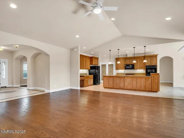 a kitchen with stainless steel appliances granite countertop a sink a stove and a refrigerator
