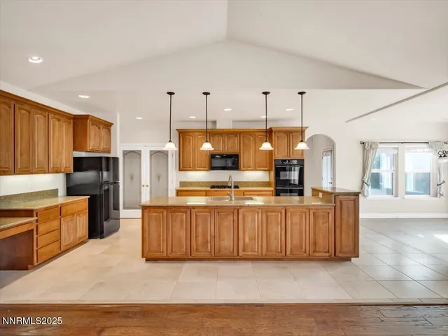 a view of a kitchen with furniture a fireplace and wooden floor
