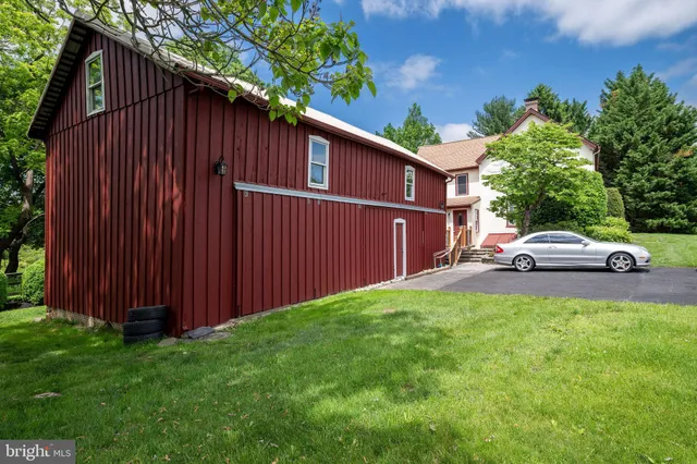a kitchen with stainless steel appliances granite countertop a stove a sink a refrigerator and a dining table