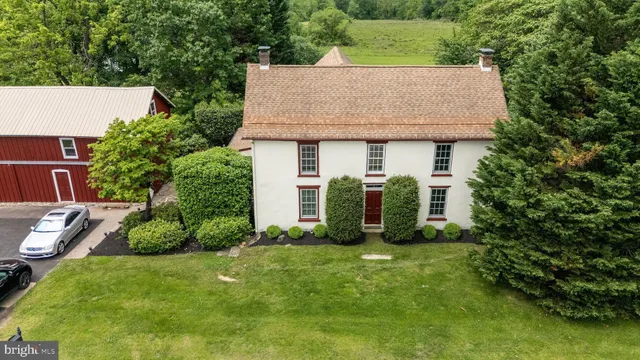 an aerial view of a house with garden space and street view