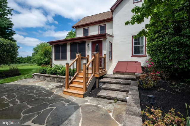 a view of a patio with table and chairs and potted plants