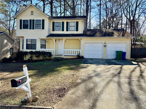 a front view of a house with a yard