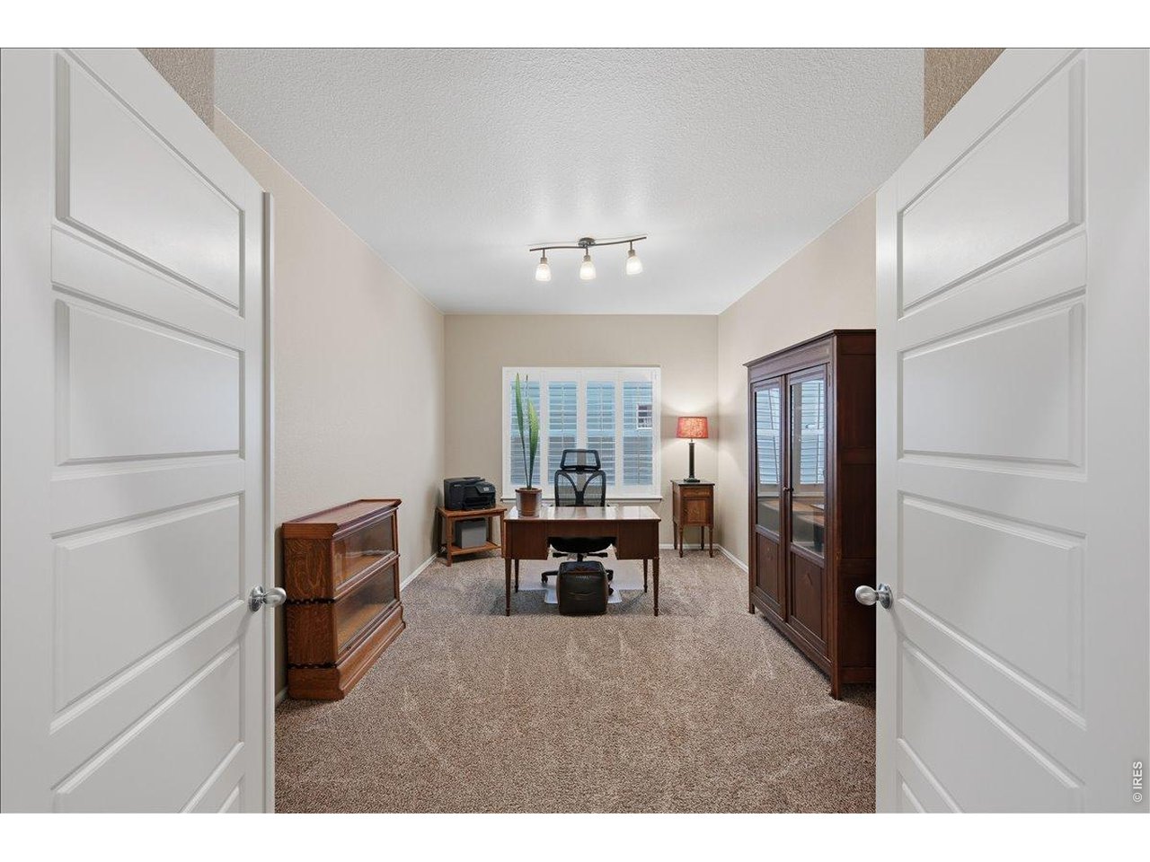 6096 Story Road Timnath, CO 80547 - Photo 27 of 50 a living room with furniture a window and a refrigerator